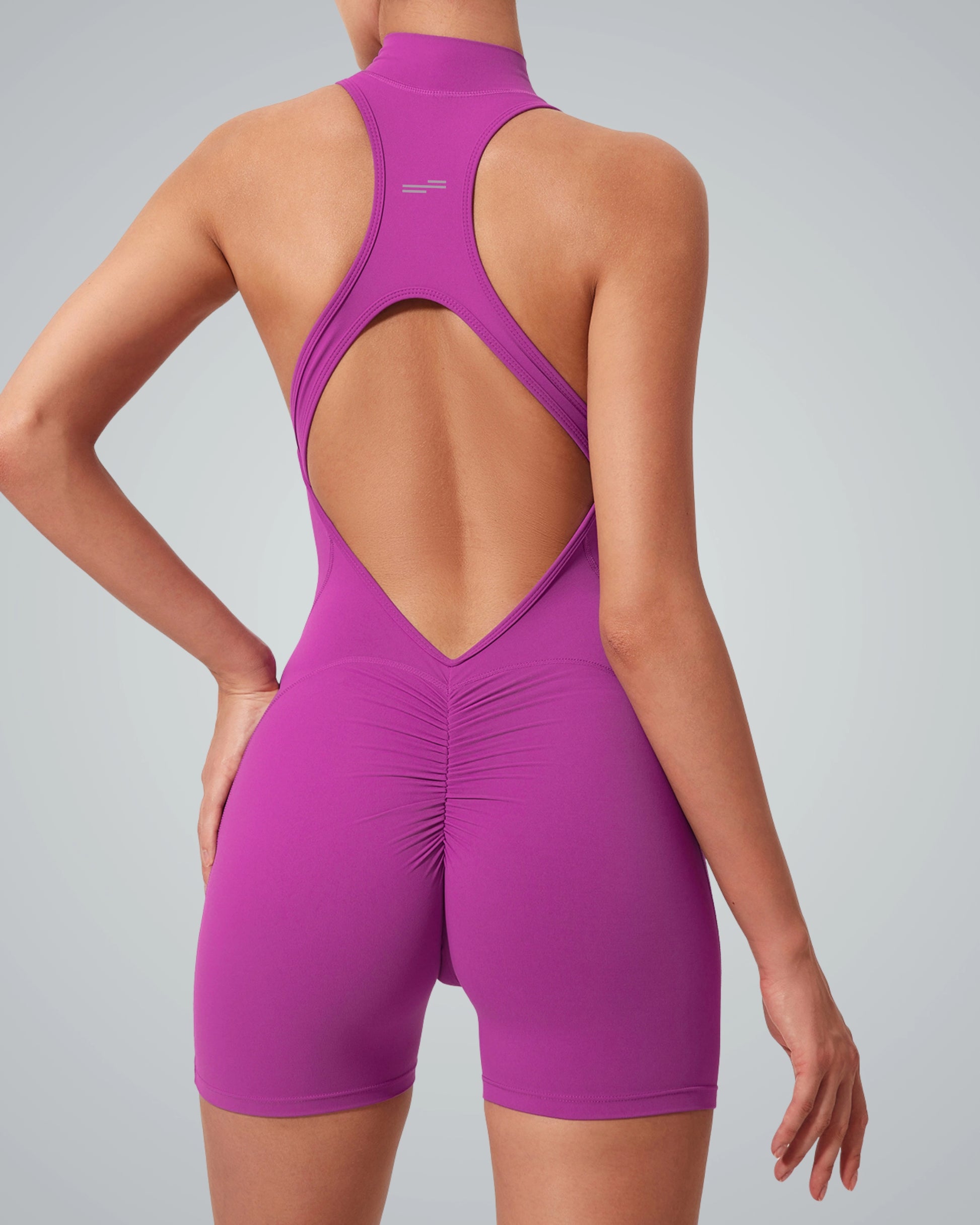 Woman wearing midnight motion bodysuit from Bandsam, showcasing stretch, flexibility, and comfort for yoga or lounging.