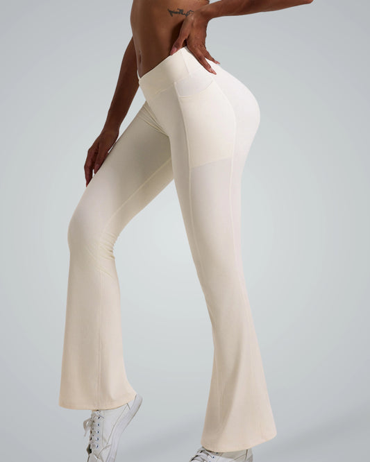 Woman wearing cream-colored Bandsam PeakFit Pocket Leggings, high-waisted and flared, ideal for yoga, pilates, or casual outings.