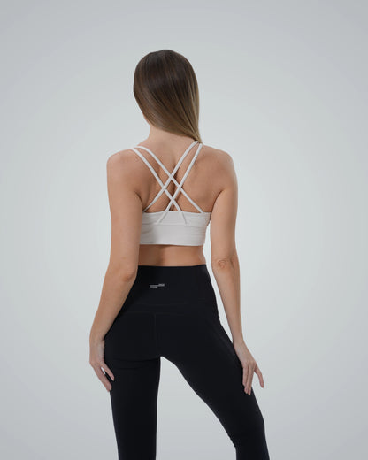 Woman wearing Bandsam PrimFit seamless sports bra and high-waisted leggings, showcasing a trendy stretch-fit two-piece activewear set.