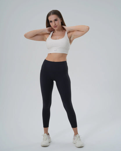 Woman wearing Bandsam PrimFit Set, a seamless sports bra and high-waisted leggings, ideal for yoga and workouts, in sleek minimalist style.