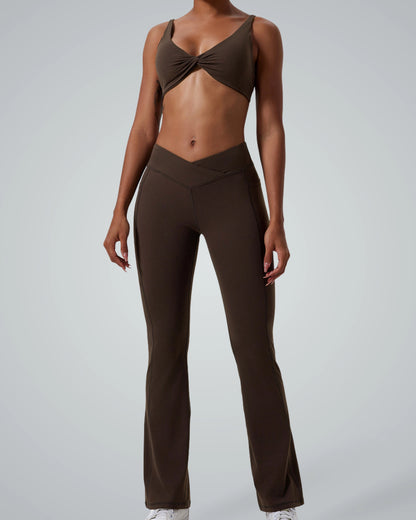 Model wearing Bandsam SculptEase twist-front sports bra and high-waisted flared trousers, two-piece activewear, seamless gym set.