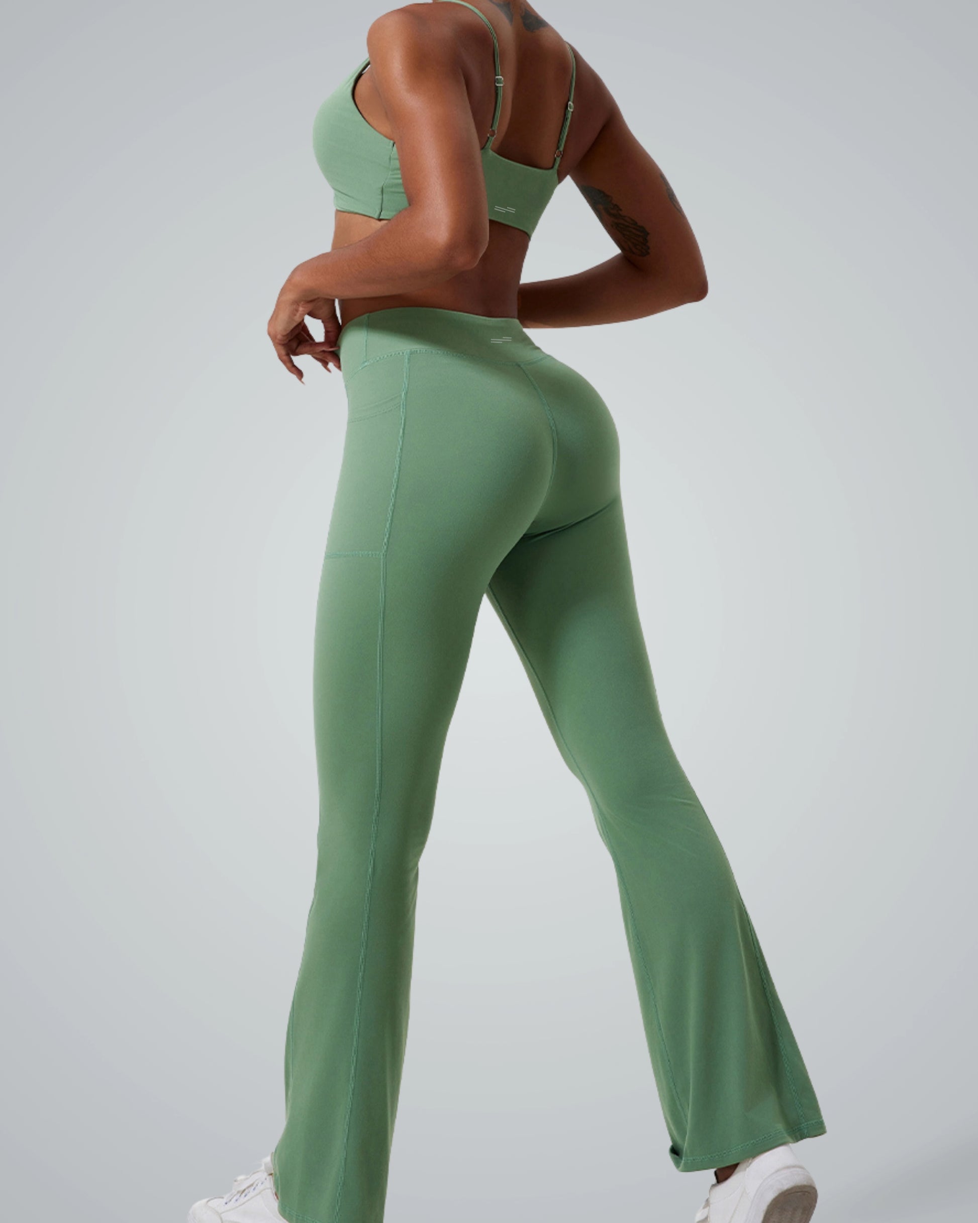 Bandsam SculptEase Set: matching yoga set with twist-front sports bra and high-waisted flared trousers in green, seamless gym outfit.