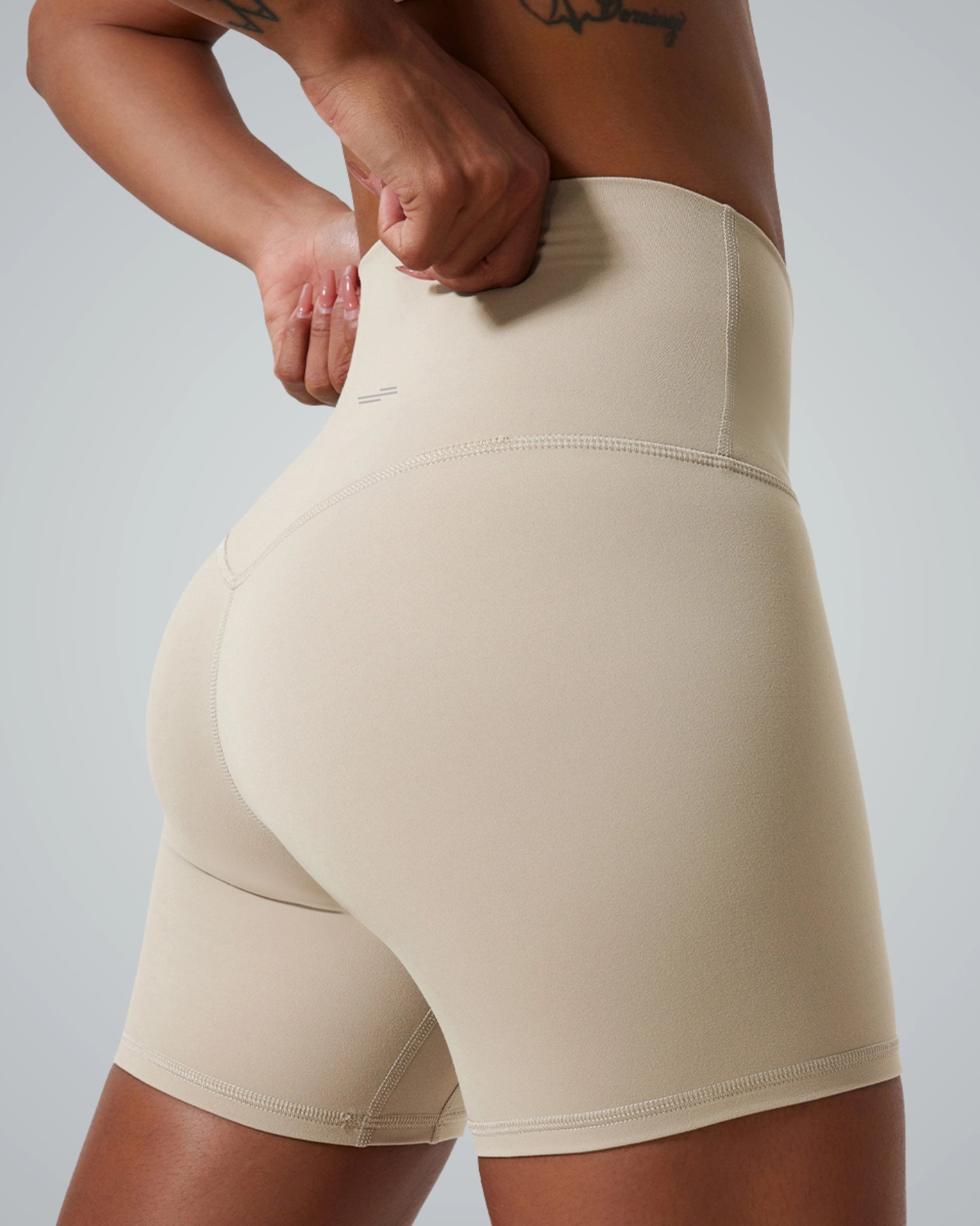 Women's Bandsam SereneFit Shorts in beige, high-waisted activewear offering stretch, comfort, and support for yoga, pilates, and workouts.