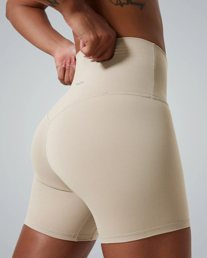 Women's Bandsam SereneFit Shorts in beige, high-waisted activewear offering stretch, comfort, and support for yoga, pilates, and workouts.