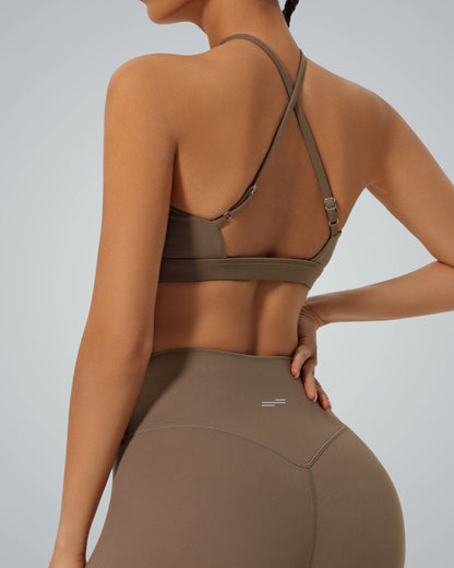 Back view of a woman wearing a Bandsam ShapeSync Bra with a crisscross design, ideal for comfort, flexibility, and support during yoga or workouts.