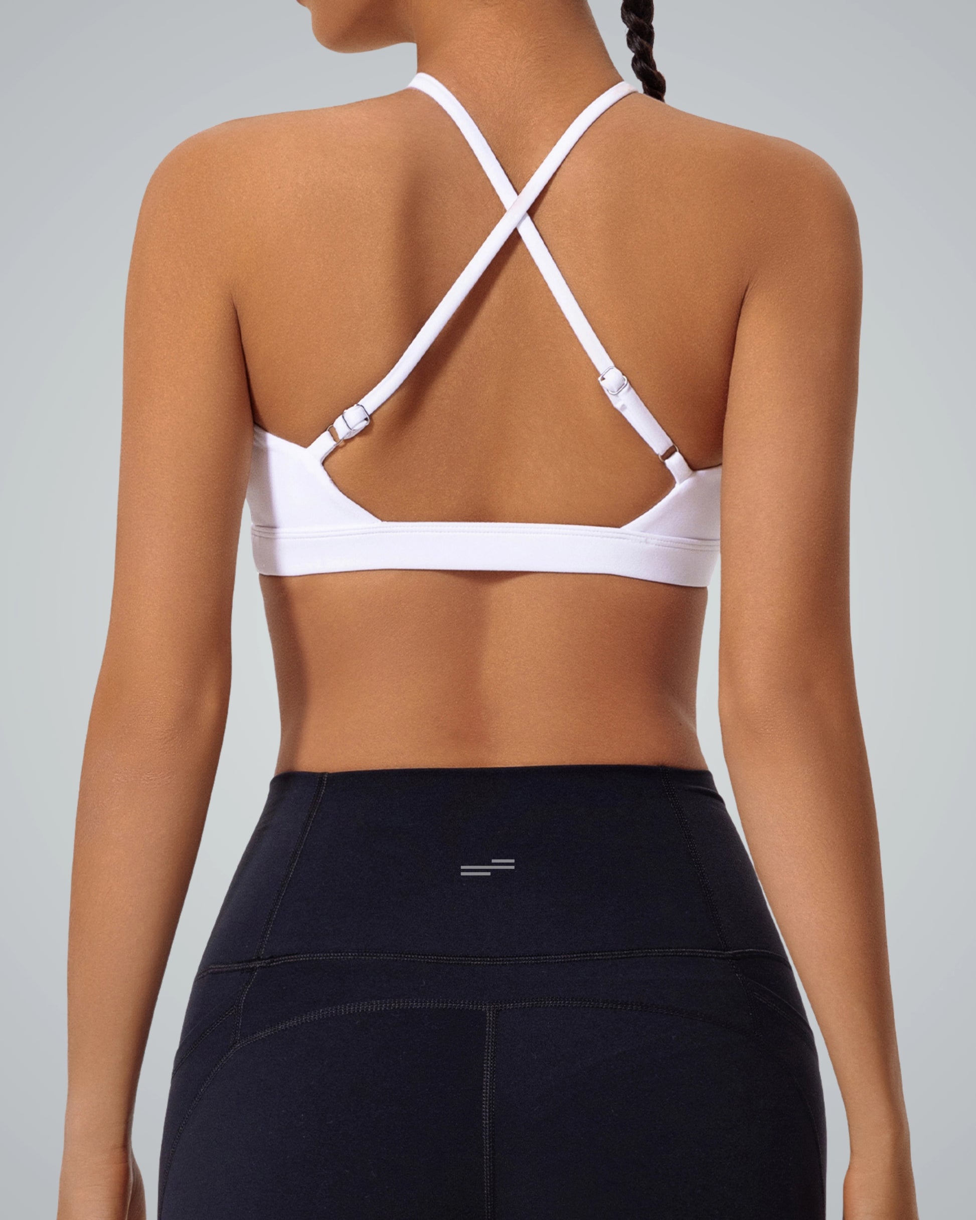 Woman wearing Bandsam ShapeSync Bra with crisscross back design, ideal for yoga, workout, and relaxation. Stretchy and supportive activewear.