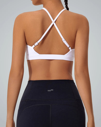 Woman wearing Bandsam ShapeSync Bra with crisscross back design, ideal for yoga, workout, and relaxation. Stretchy and supportive activewear.