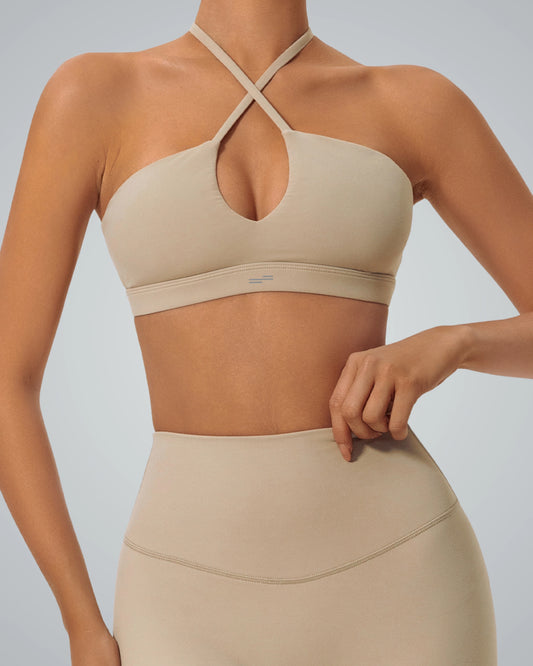 Bandsam ShapeSync Bra in beige with crisscross design, offering stretch, comfort, and support for active women in yoga or workouts.