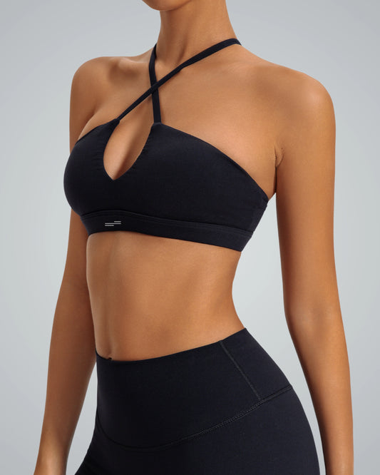 Woman wearing Bandsam ShapeSync Bra in black, showcasing crisscross design, perfect for yoga, pilates, workout, offering comfort and support.