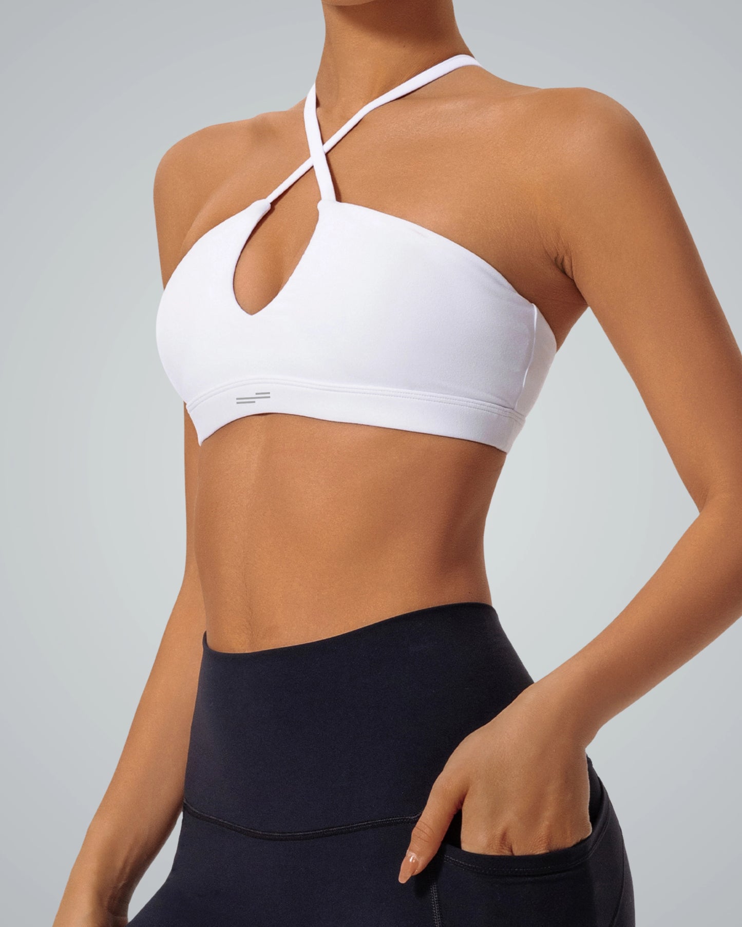 Bandsam ShapeSync Bra in white, featuring a modern crisscross design, offering stretch and support for yoga, Pilates, and everyday comfort.