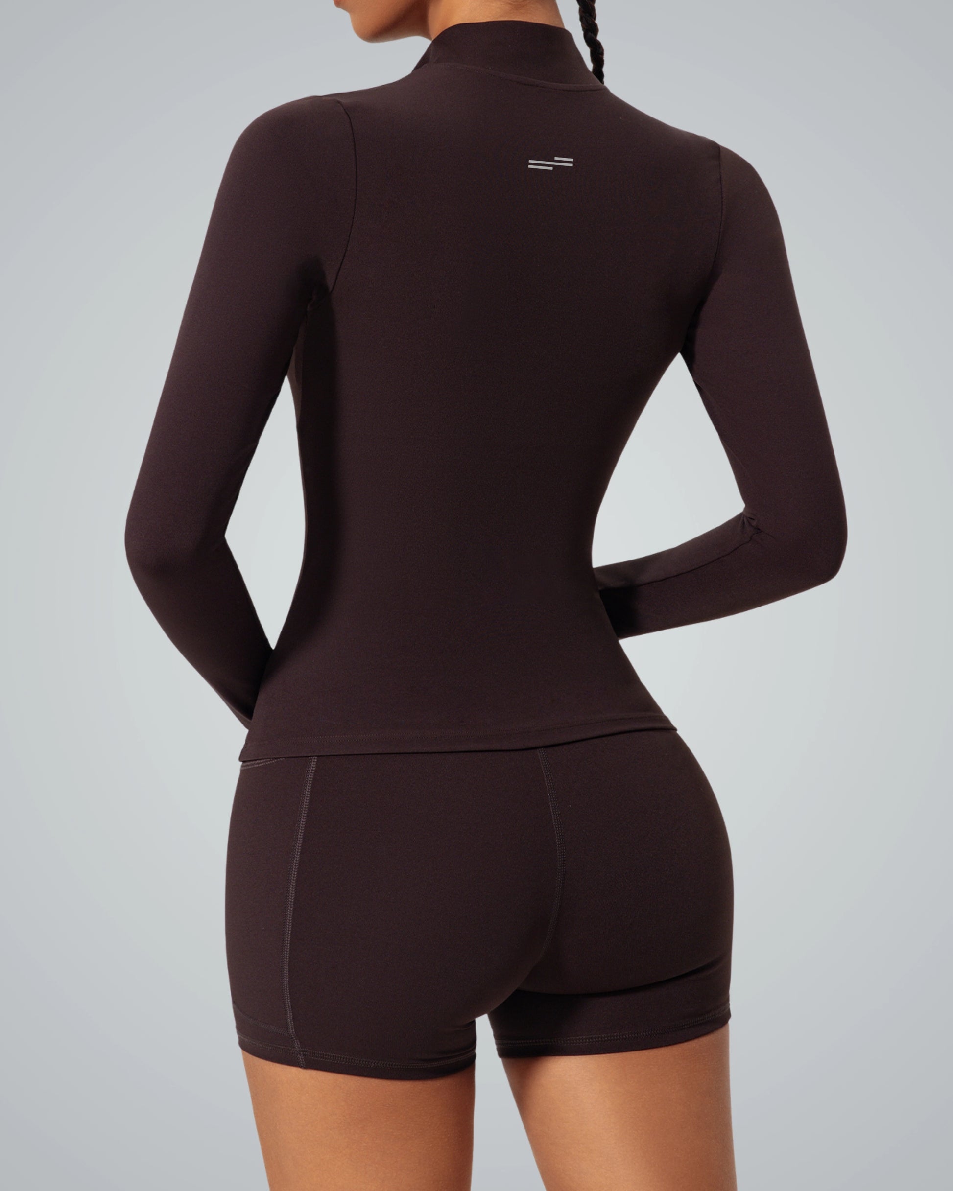 Woman wearing Bandsam SmoothFit Long Sleeve, ergonomic design, soft black fabric, ideal for yoga, pilates, activewear, and comfort.