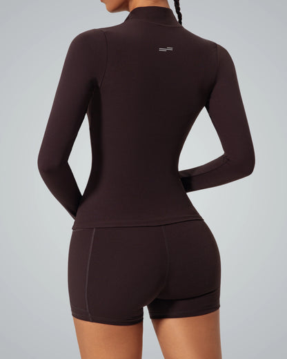 Woman wearing Bandsam SmoothFit Long Sleeve, ergonomic design, soft black fabric, ideal for yoga, pilates, activewear, and comfort.