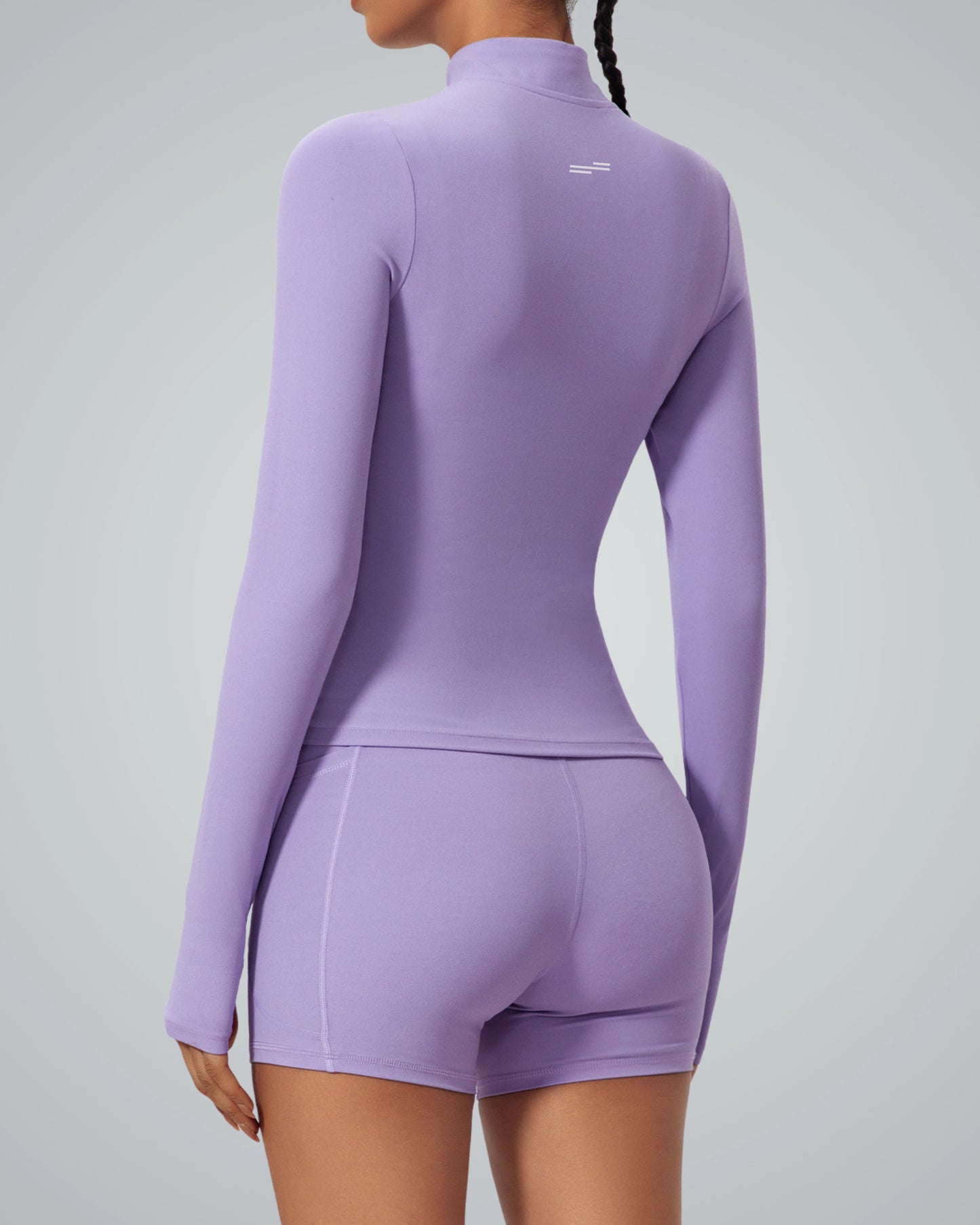Woman in purple Bandsam SmoothFit Long Sleeve, showcasing stretch and flexibility. Ideal for activewear, yoga, pilates, or lounging.