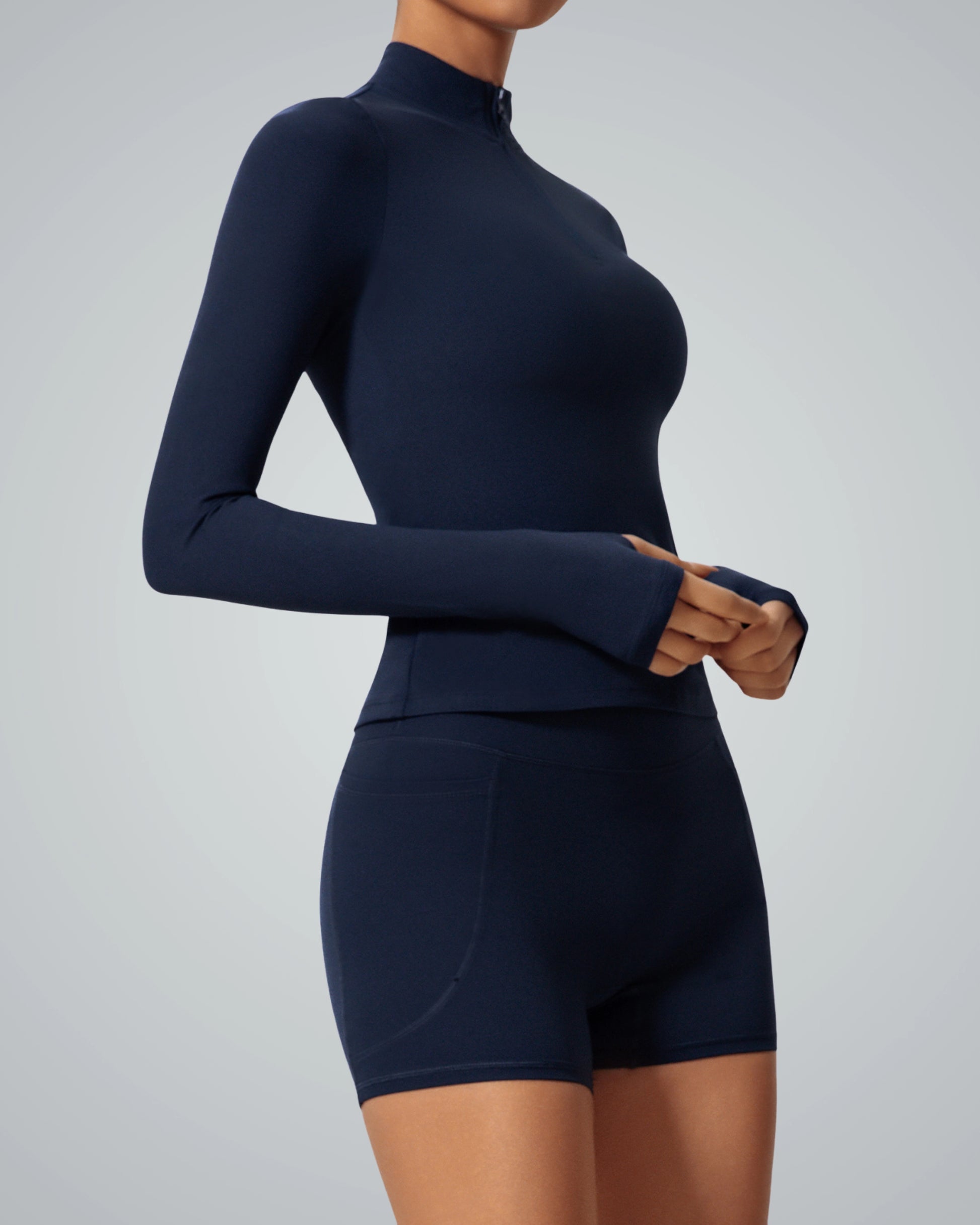 Woman wearing Bandsam SmoothFit Long Sleeve in navy blue, showcasing stretch, comfort, and flexibility for yoga, pilates, and lounging.