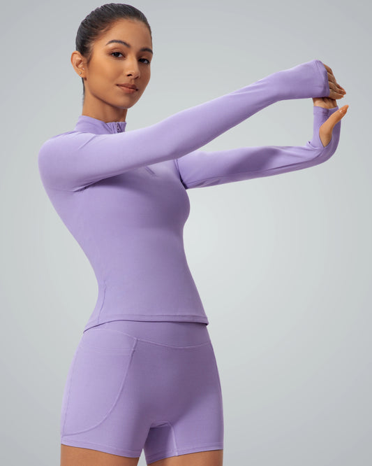 Woman wearing Bandsam SmoothFit Long Sleeve in lilac, ideal for yoga and workouts, offers style, stretch, and comfort.