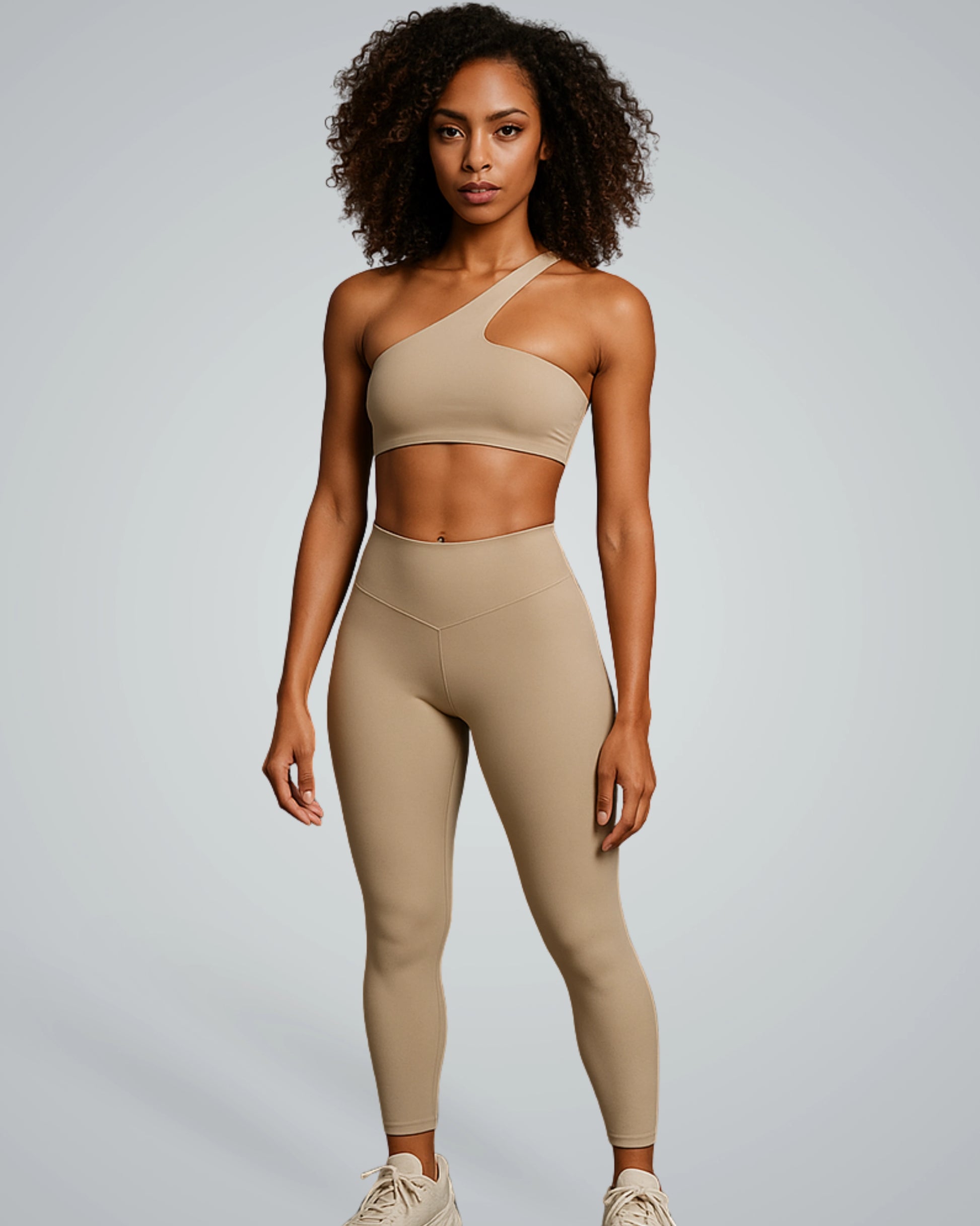 ToneTwin Set by Bandsam in beige, featuring an asymmetrical sports bra and high-waisted leggings. Ideal seamless gym set for women.