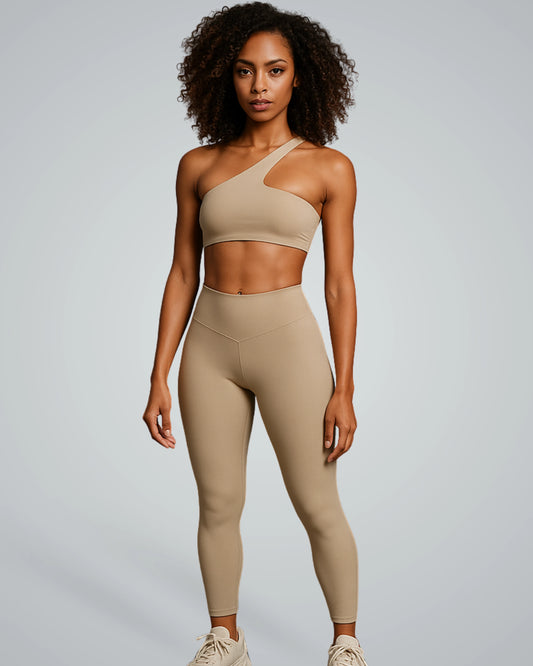 ToneTwin Set by Bandsam in beige, featuring an asymmetrical sports bra and high-waisted leggings. Ideal seamless gym set for women.