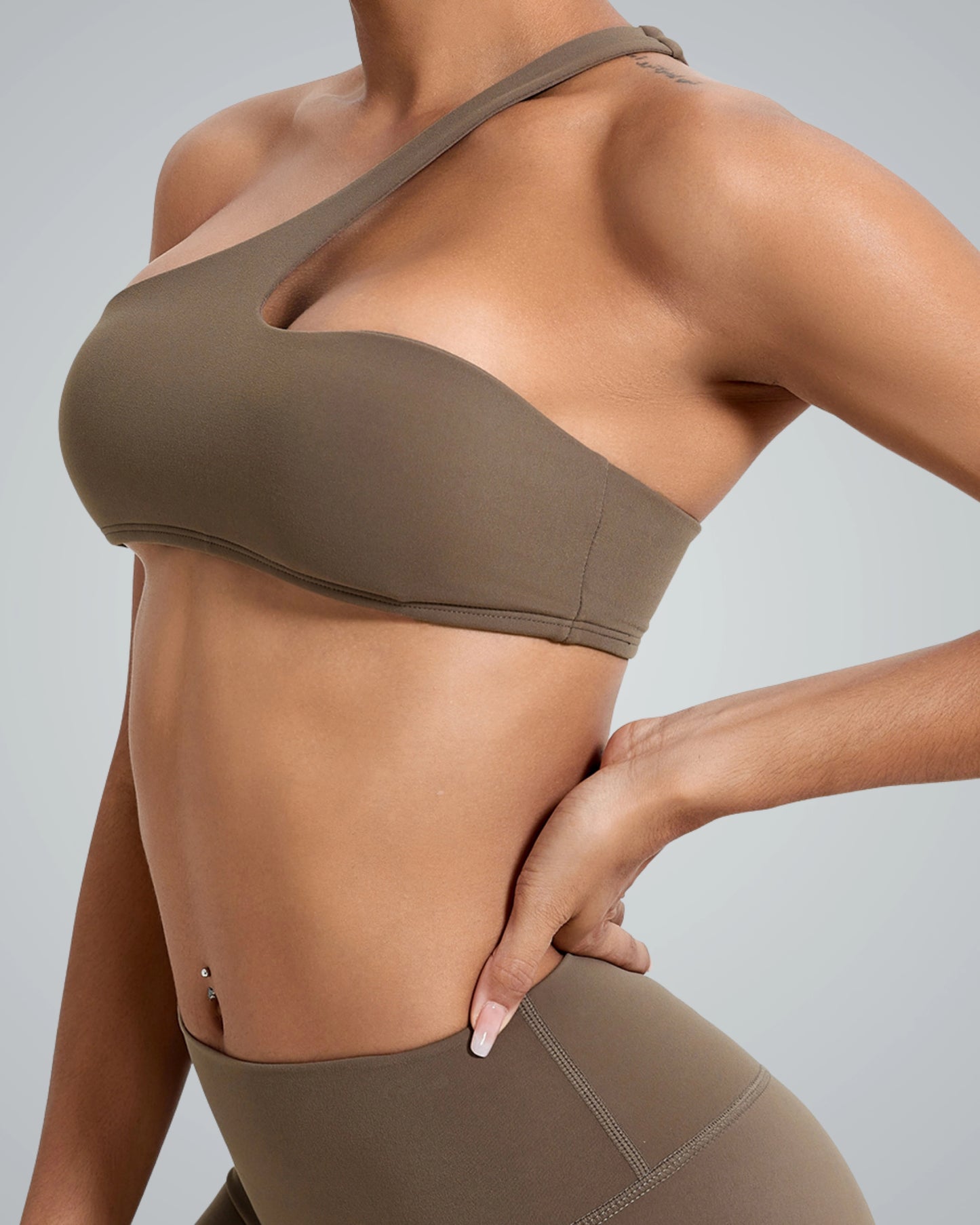 Asymmetrical sports bra and high-waisted leggings, ToneTwin Set by Bandsam. A minimalist gym set for comfortable and stylish workouts.