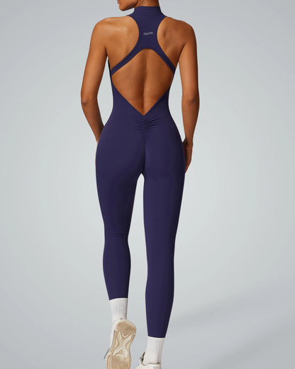 Back view of woman wearing Bandsam VelocityVibe Jumpsuit in navy, showcasing stretch, activewear comfort, support, and flexibility.