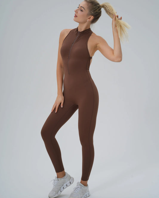Woman wearing Bandsam VelocityVibe Jumpsuit in brown, showcasing high-neck design, ideal for yoga, pilates, and lounging, combining style and comfort.