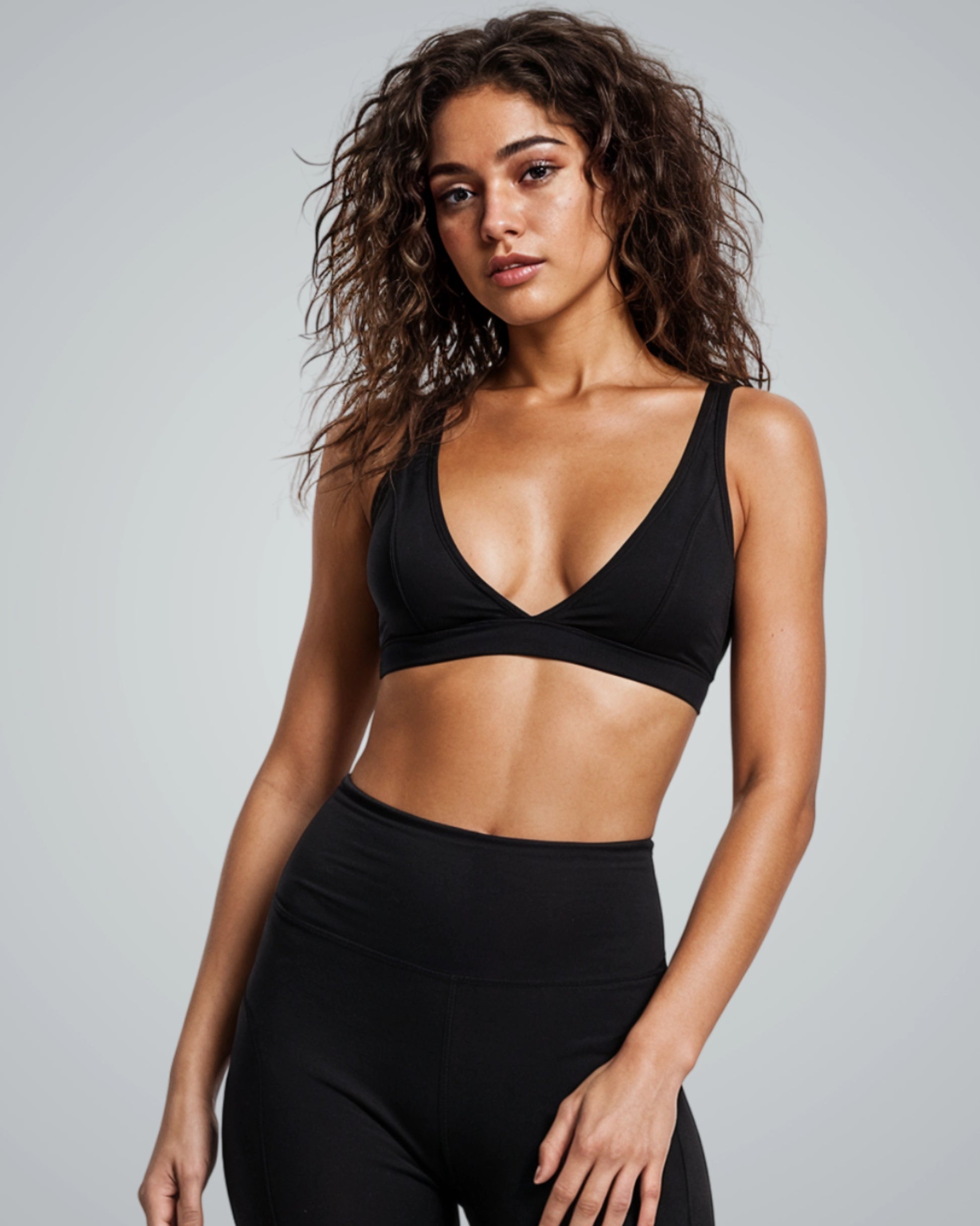 Woman wearing Bandsam Verda Vibe Bralette in black, ideal for yoga, pilates, lounging; offers stretch, support, and soft comfort for women.