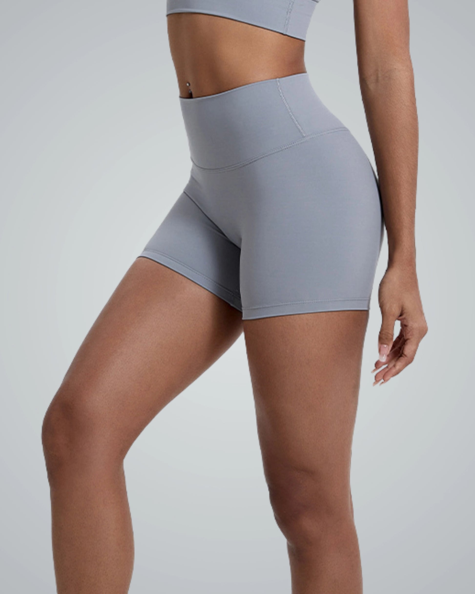 Woman wearing gray Bandsam VibrantMove Shorts, ideal for yoga, pilates, lounging, with stretch and comfort for activewear.