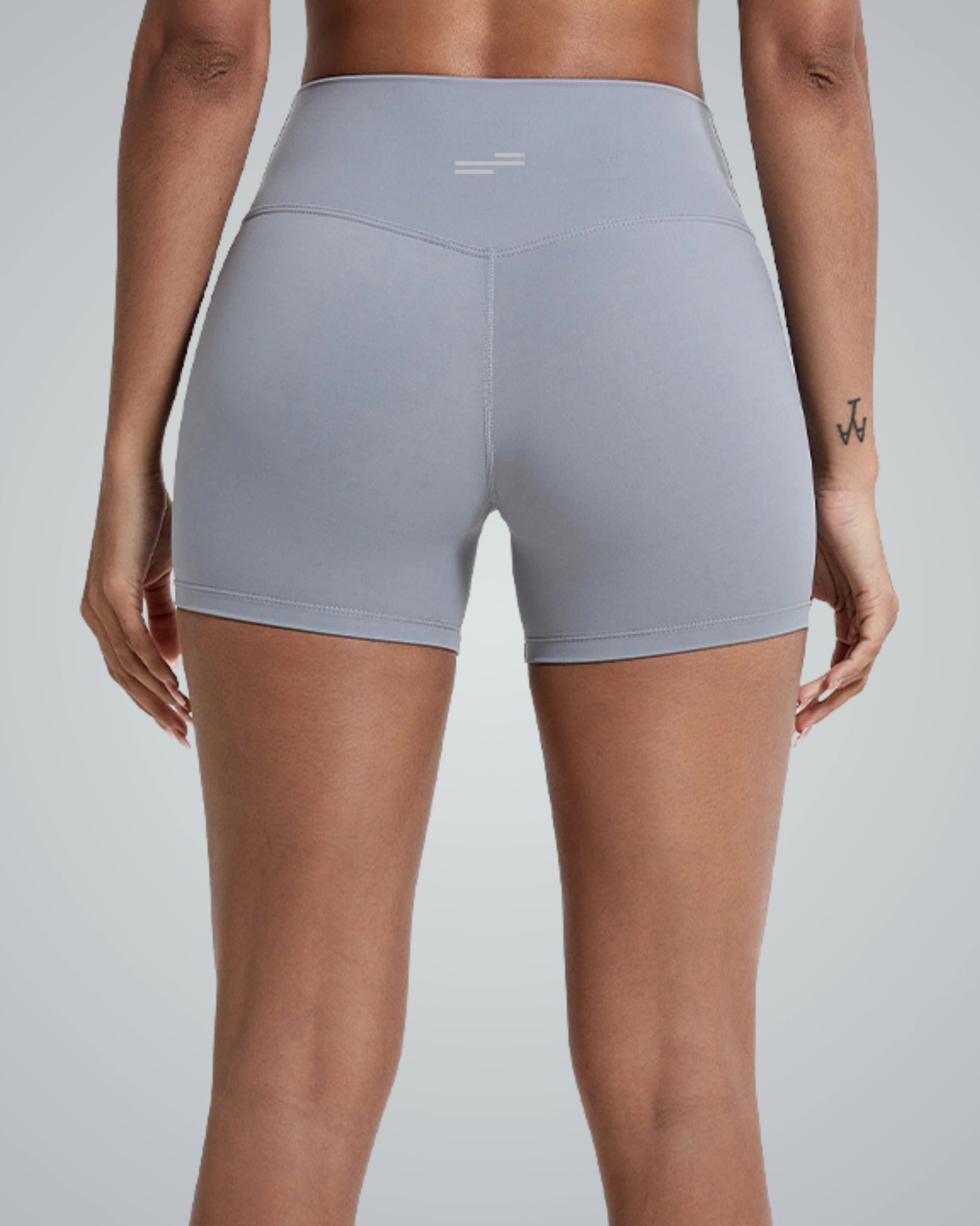Rear view of a woman wearing Bandsam VibrantMove Short in gray, ideal for yoga, pilates, and activewear. Features flexibility and comfort.