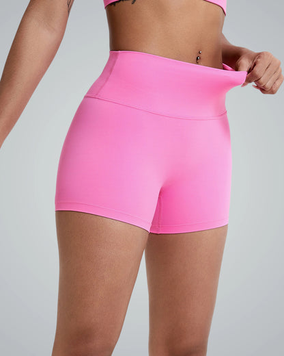 Woman wearing pink Bandsam VibrantMove Shorts, showcasing stretch activewear for yoga, pilates, and workouts emphasizing comfort and flexibility.