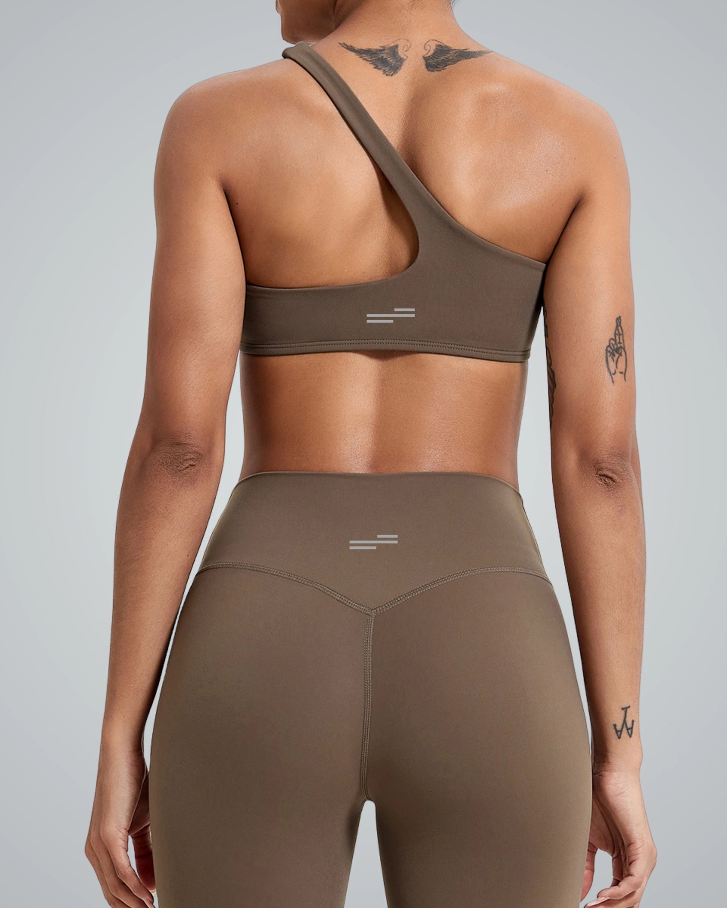 Back view of woman wearing Bandsam Zenith Solo Bra, showcasing stretch activewear perfect for yoga and workouts, in soft brown fabric.