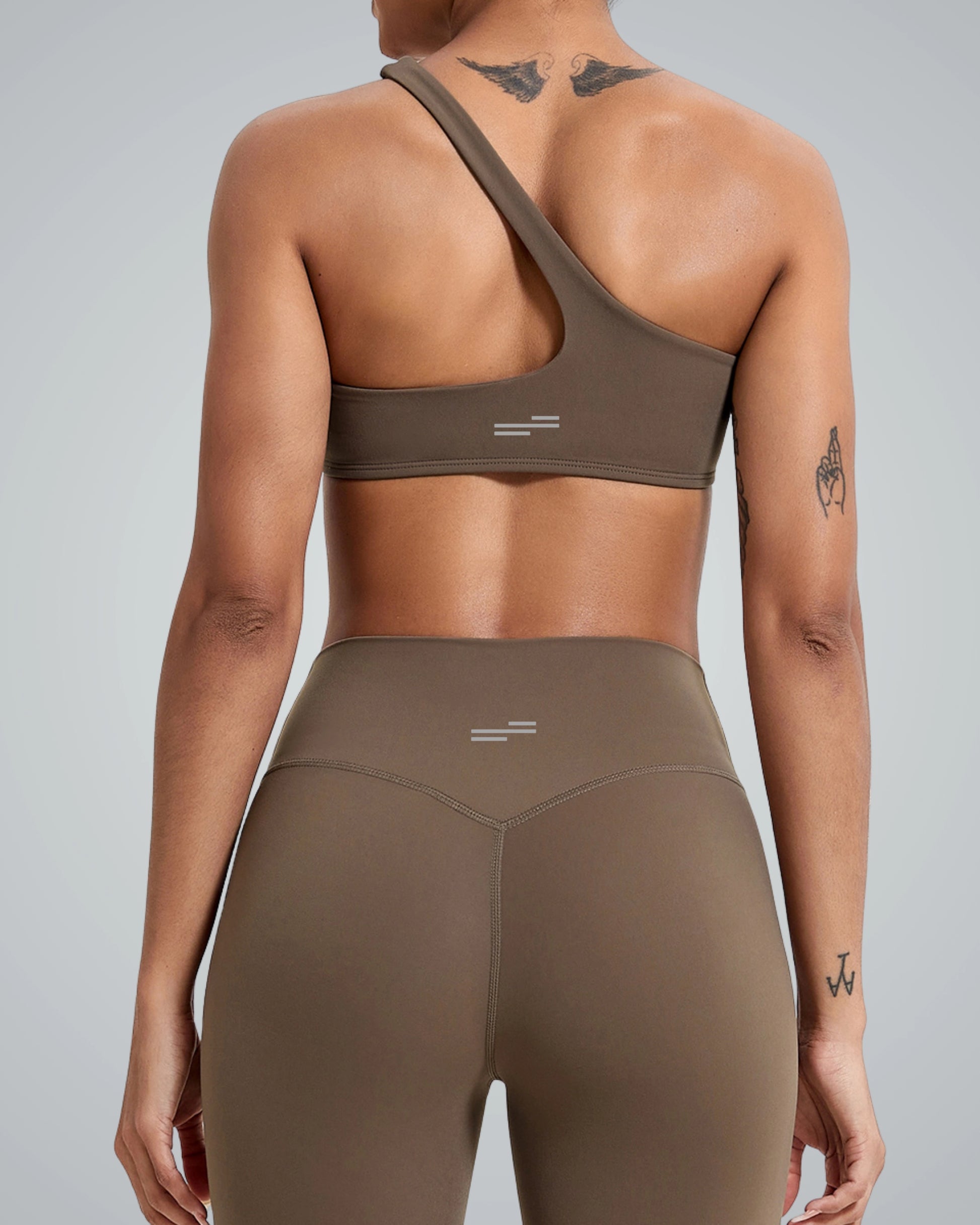 Back view of woman wearing Bandsam Zenith Solo Bra, showcasing stretch activewear perfect for yoga and workouts, in soft brown fabric.