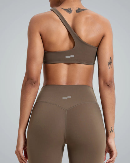 Back view of woman wearing Bandsam Zenith Solo Bra, showcasing stretch activewear perfect for yoga and workouts, in soft brown fabric.
